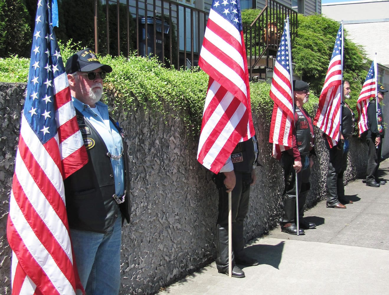 Patriot Guard Riders participate in a flag line outside Straub's Funeral Home, in Camas Friday, during the memorial service for Master Sgt. Ed Spencer. Spencer, of Washougal, was a decorated Army veteran who served two tours in Vietnam. &quot;It is our way of honoring and thanking Master Sgt. Spencer for the self-sacrifices he made by serving our country,&quot; said Lynn Vaughn, a Southwest Washington ride captain.