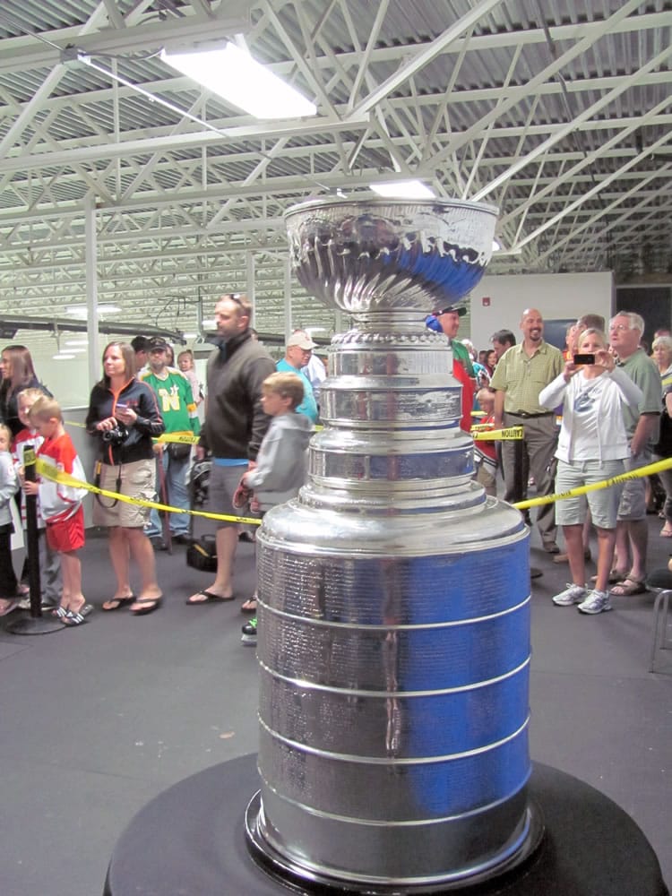 Hockey fans line up to touch the Stanley Cup Wednesday, at the Mountain View Ice Arena in Vancouver.