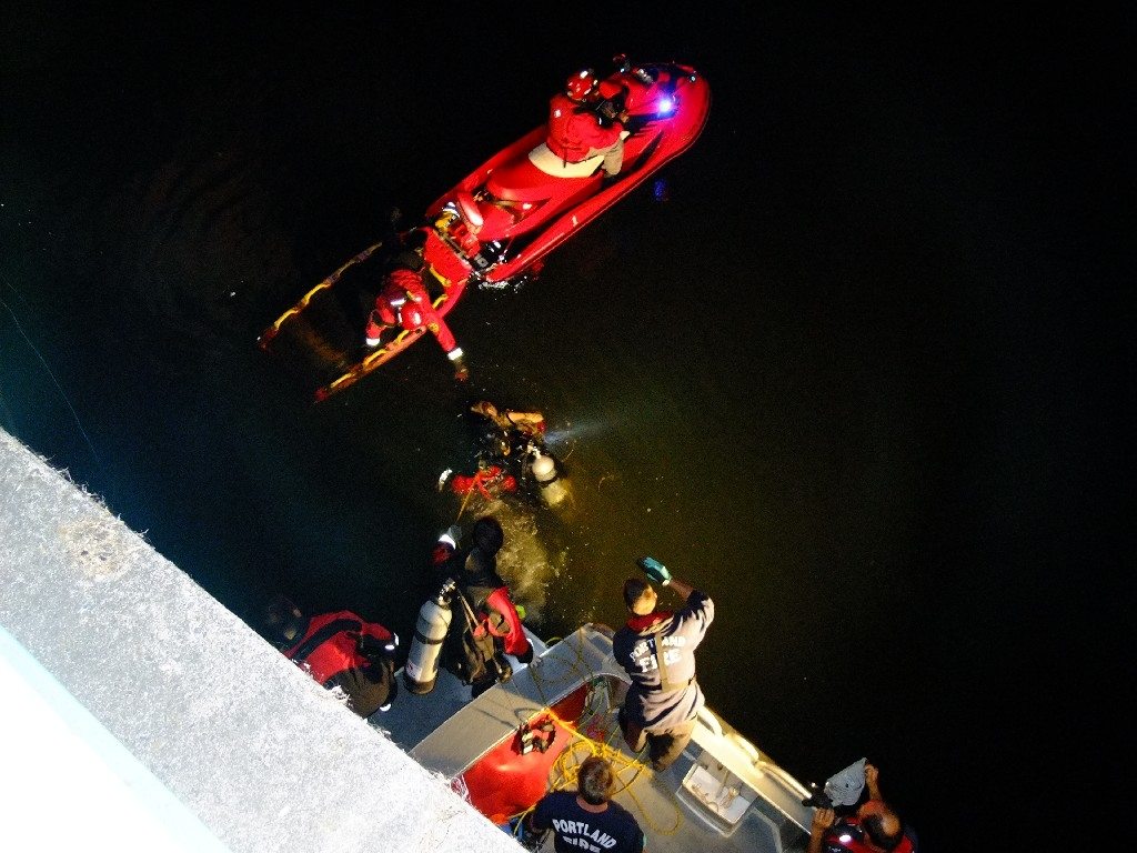 The Portland dive team recovers a body from the Willamette River early Friday.