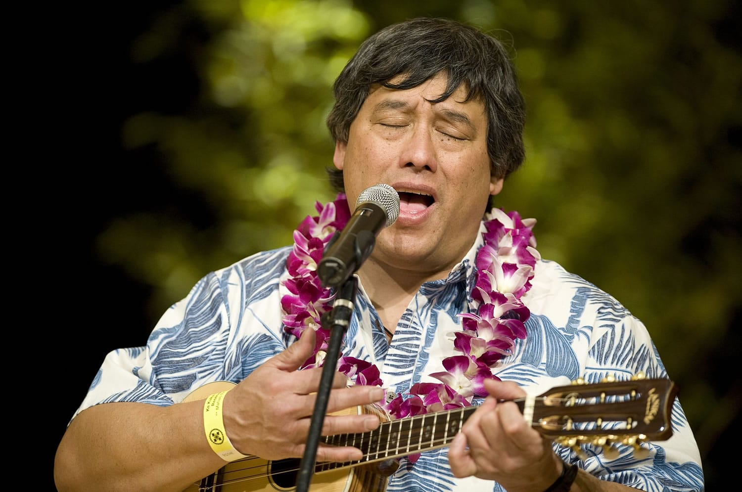 Francis Doo sings traditional Hawaiian music before dinner Saturday at the Ke Kukui Foundation Cultural Lu'au at Thomas Jefferson Middle School.