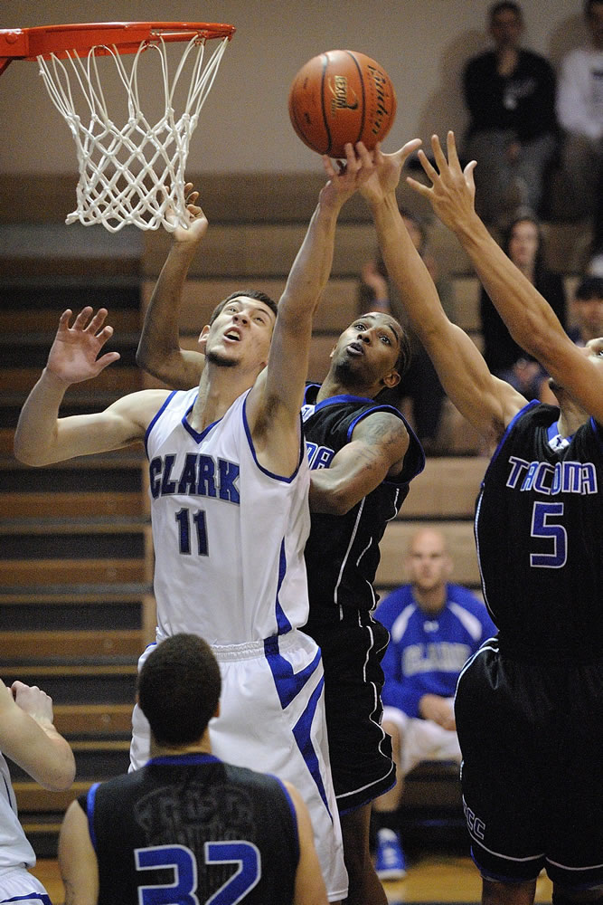 Clark College's Austin Bragg (11) battles for a rebound against Demetrius Smith, left, and Julian Vaughn (5)of Tacoma.