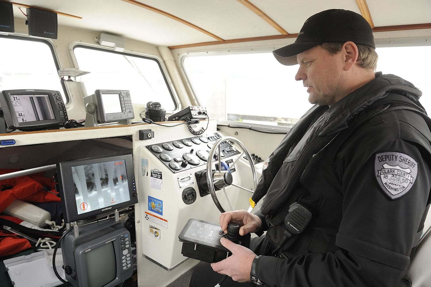 Deputy Todd Baker shows how an infrared imaging system works in the cabin of the refurbished Marine Patrol boat William Ryan.