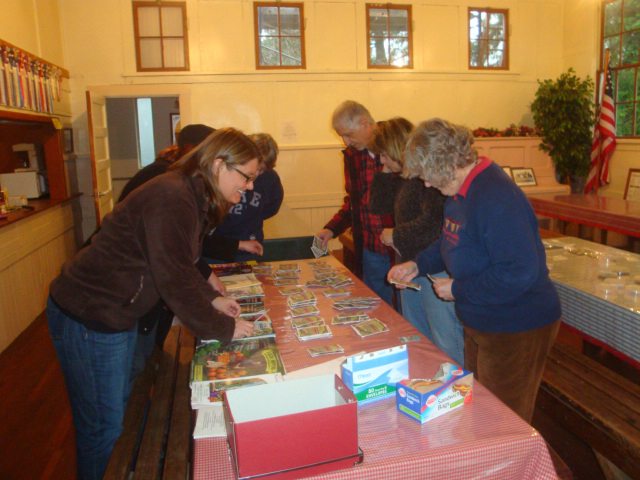 Venersborg: Kristen McHenry, left front, and Susan Tripp, front right, swap seeds with other gardeners Jan.