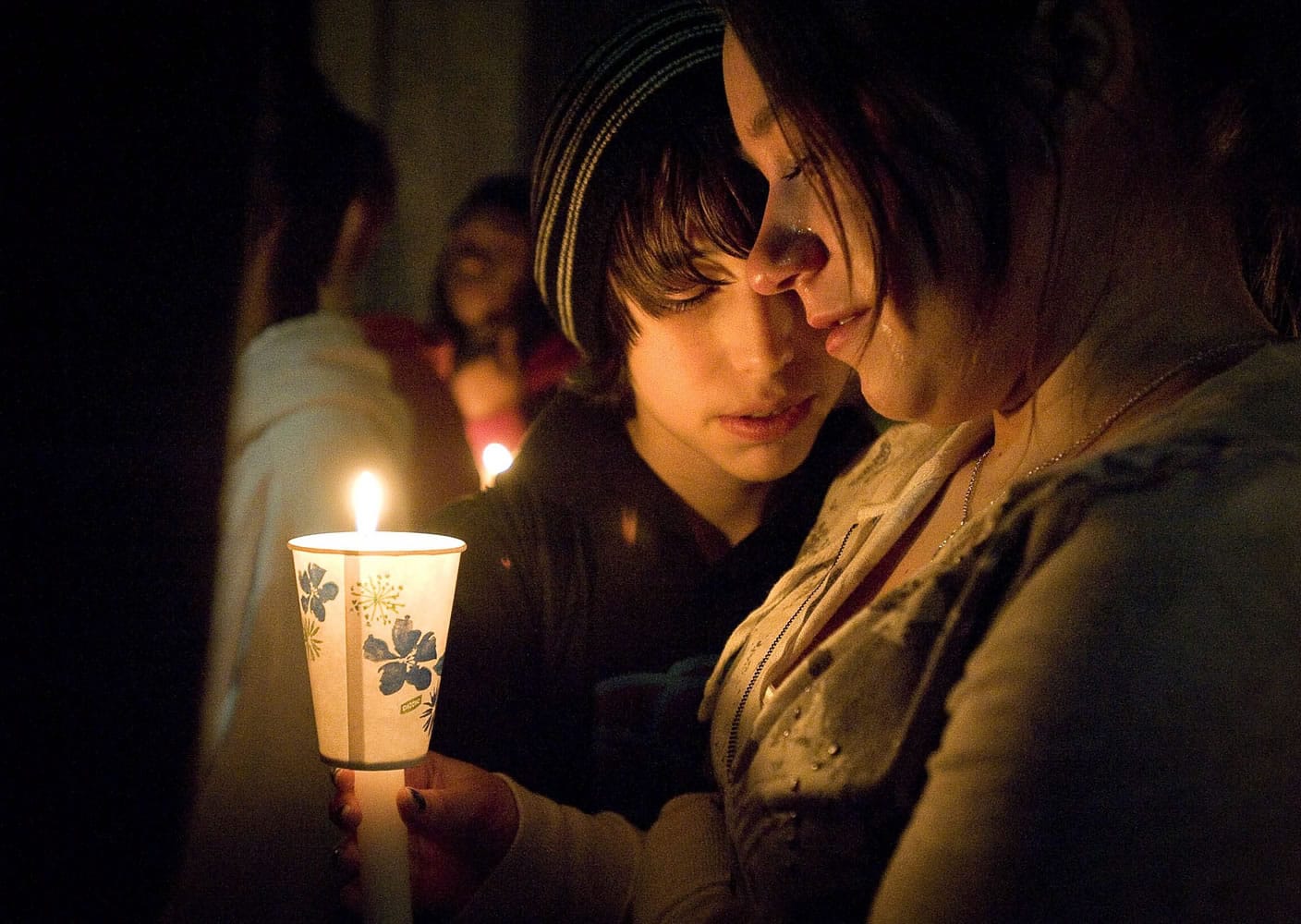Ryan Newman, left, comforts Vivi Nikolaychuk during a candlelight vigil for their friend Eden Van Horn at Cascade Middle School.