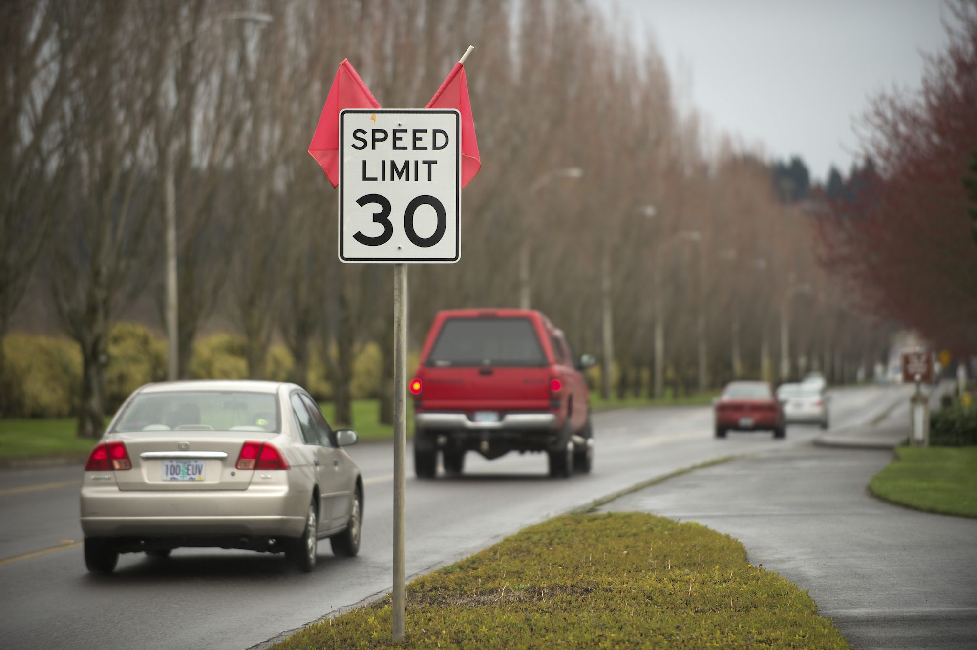 Traffic passes by a sign announcing the new 30 mph speed limit on Southeast Columbia Way in Vancouver.