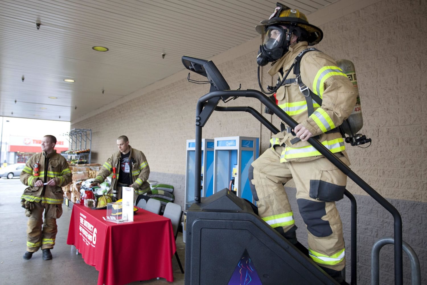 Photos by Vivian Johnson/ for The Columbian
Scott Squires, who fought and beat lymphoma in the past decade, rides a StairMaster outside the Hazel Dell Fred Meyer to raise money and awareness for the Lymphoma &amp; Leukemia Society.  Squires and other firefighters will participate in an annual stair-climb fundraiser in Seattle, as well.