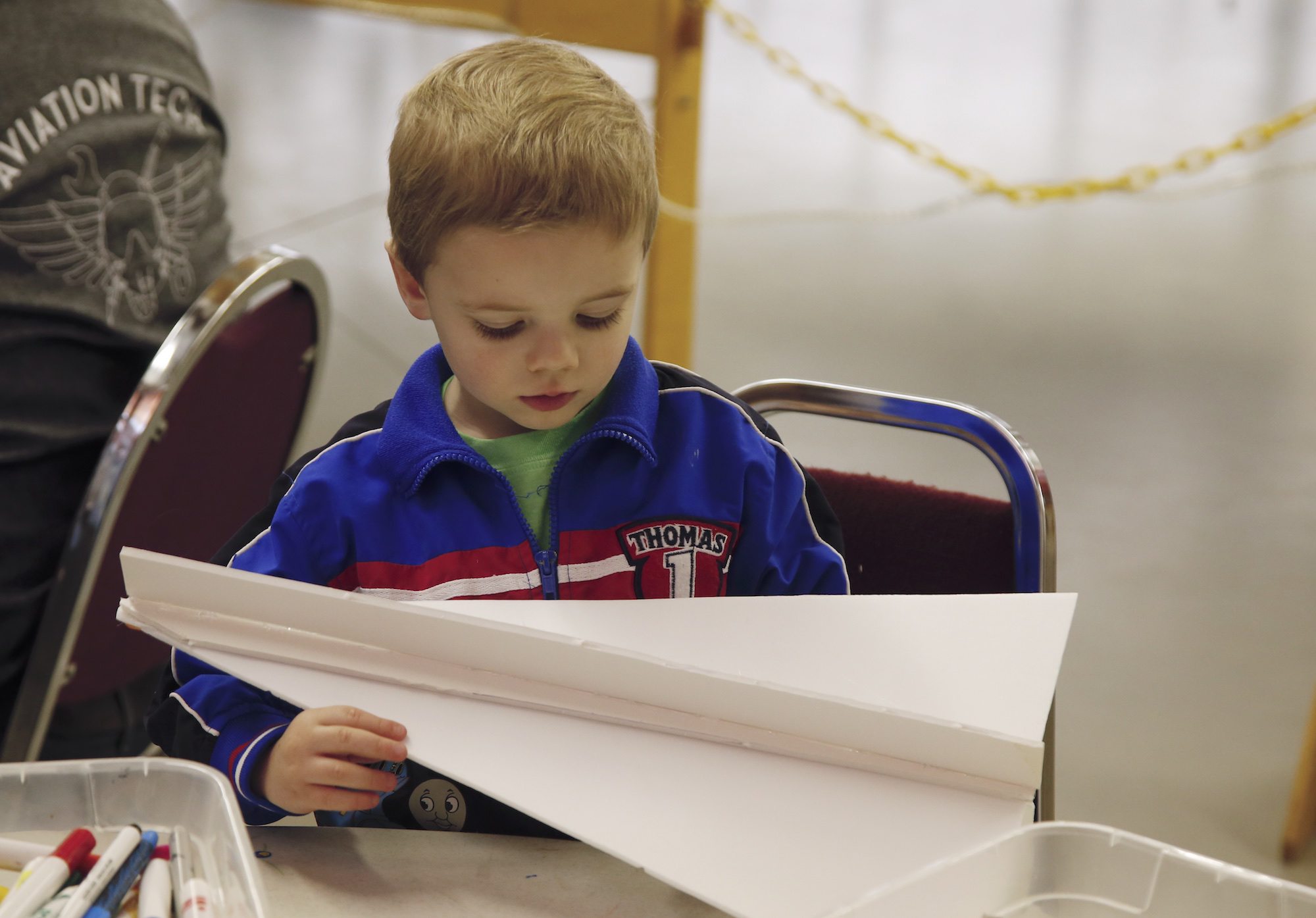Hunter Ryan, 3, works on a glider at the Pierson Field Education Center. The center hosted a weekend of flight simulation and model-glider building for kids.