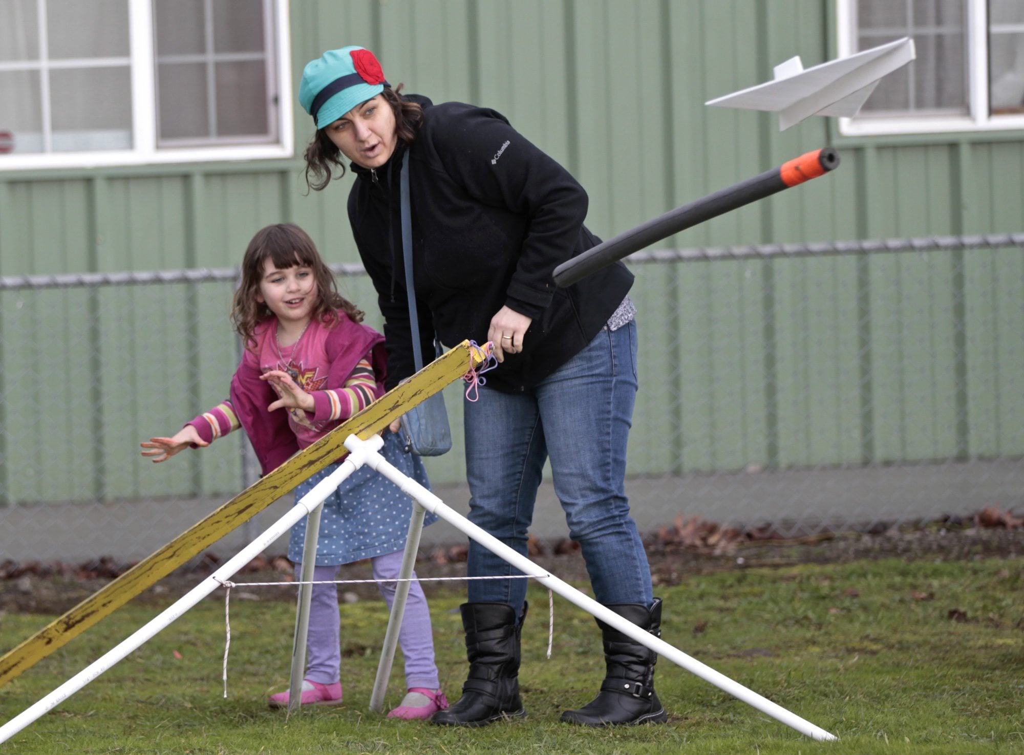 Vivian Larson, 4, and Danielle Galipeau (mom) of Portland launch a glider at the Pearson Field Education Center. The center hosted a day of flight simulation and model-glider building for kids.