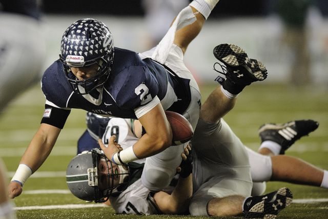 Kieran McDonagh, 2, of Skyview High School loses the football temporarily as he is tackled by Joe Beattie, 67, of Skyline High School during the Class 4A state championship football game December 3, 2011 at the Tacoma Dome in Tacoma, Washington.