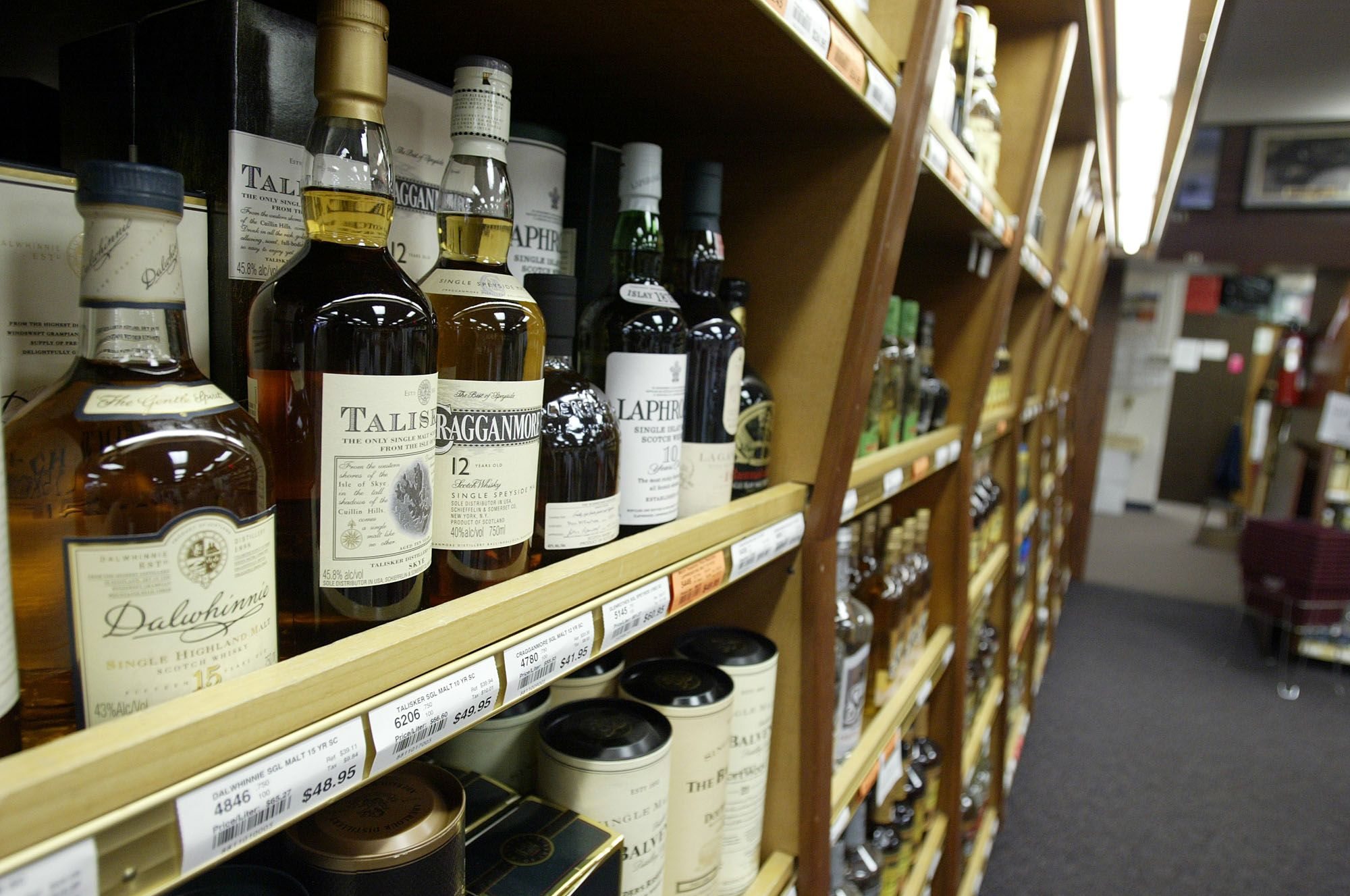 Bottles of scotch sit on a shelf at a state liquor store in Tumwater.
