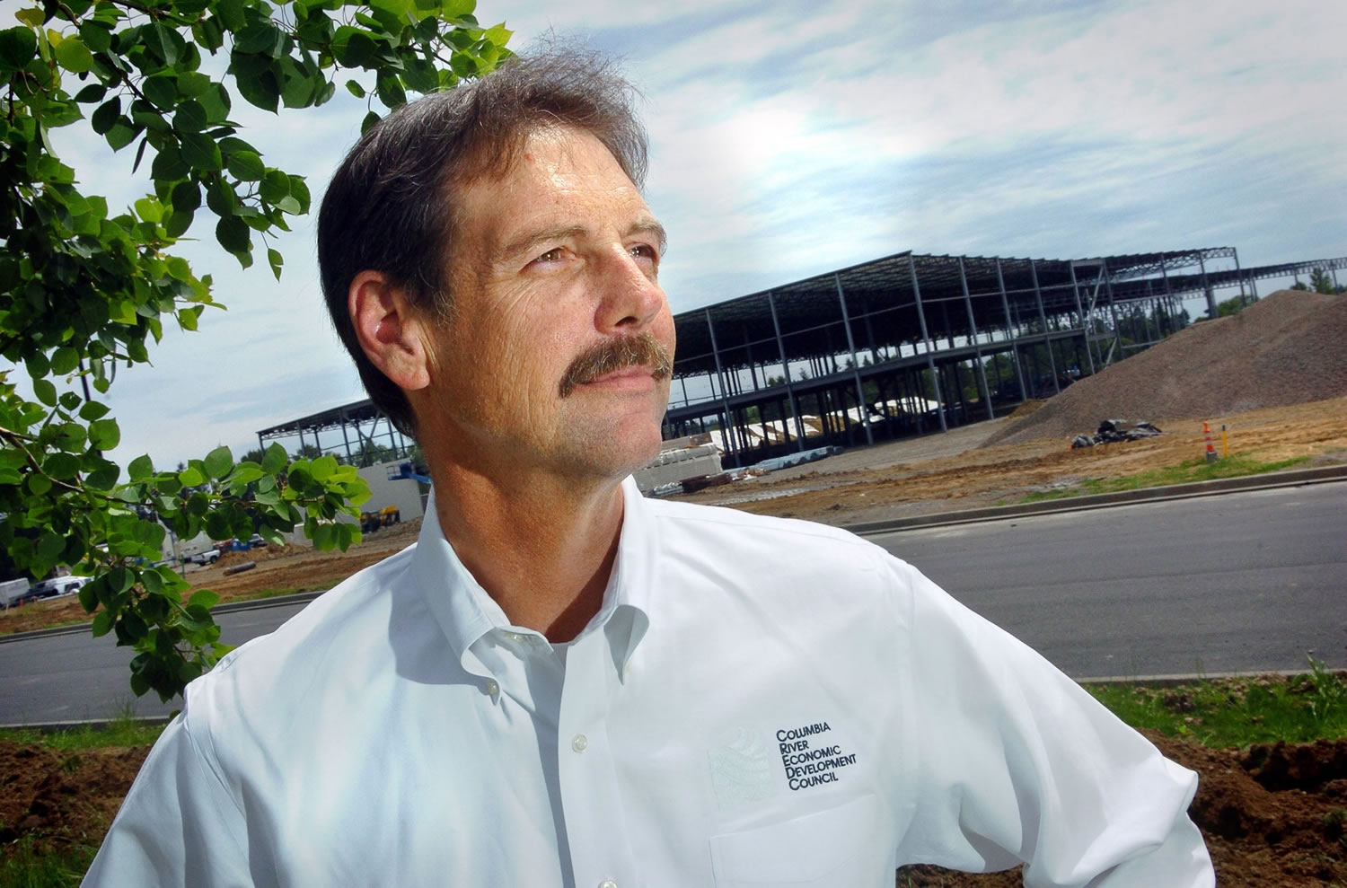 Bart Phillips, former president of the Columbia River Economic Development Council, stands in front of a United Natural Food Distribution facility while it was under construction in the Union Ridge Industrial Park in 2007.