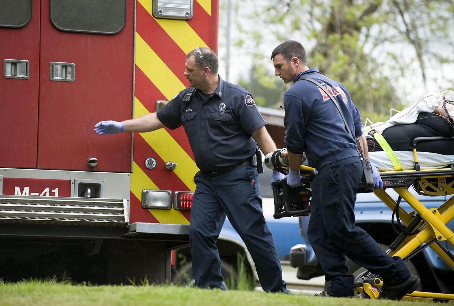 East County Fire and Rescue firefighters Capt. Wesley Long, left, and John Prasch transport a patient to a waiting ambulance.