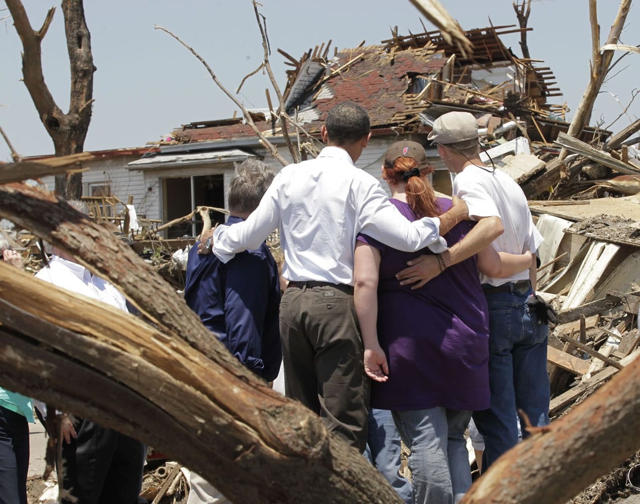 President Barack Obama, second from left, with residents views damage from the tornado that devastated Joplin, Mo., Sunday.