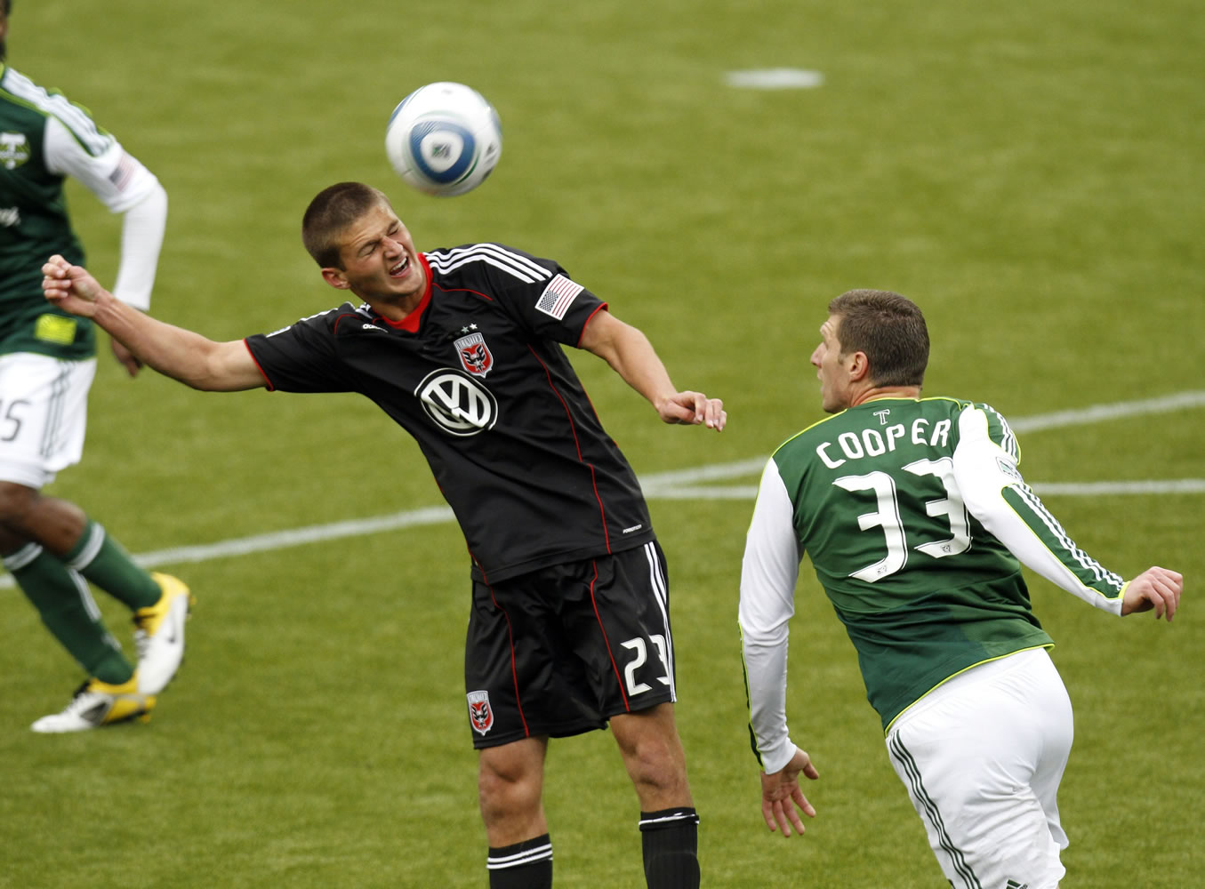 DC United defender Perry Kitchen, left, heads the ball over Portland Timbers forward Kenny Cooper during the first half Sunday at Jeld-Wen Field.