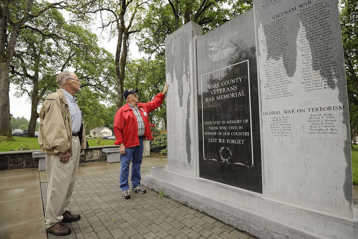 Richard Landis, left, a retired Army officer, and Navy veteran Chuck Jones check the updated Clark County Veterans War Memorial.