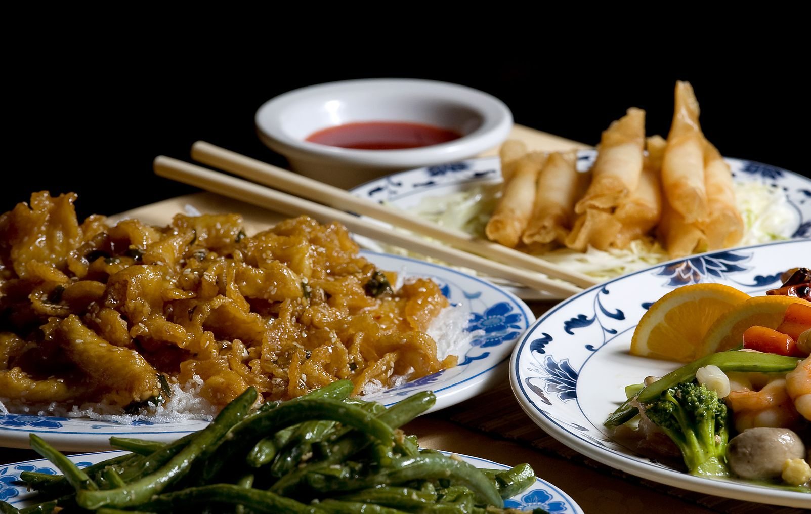 The Crispy Shrimp Rolls (clockwise from top), Dragon and Phoenix, Sauteed String Beans and Sesame Chicken were memorable dishes at the Golden City.