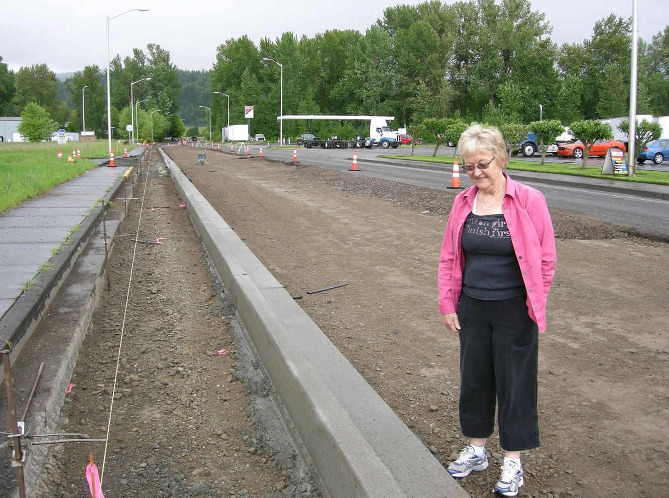 Darlene Johnson, co-owner of Woodland Truck Line, examines a Schurman Road reconstruction project that reduces the roadway's width by six feet.