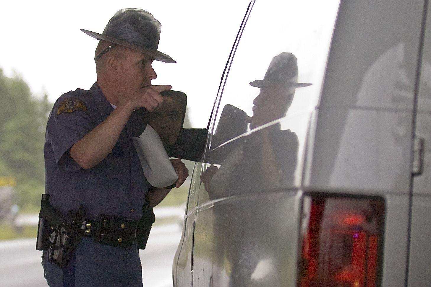 Washington State Patrol Trooper Steve Robley gives a ticket to a man who was talking on his cellphone while driving in Vancouver in June 2010.