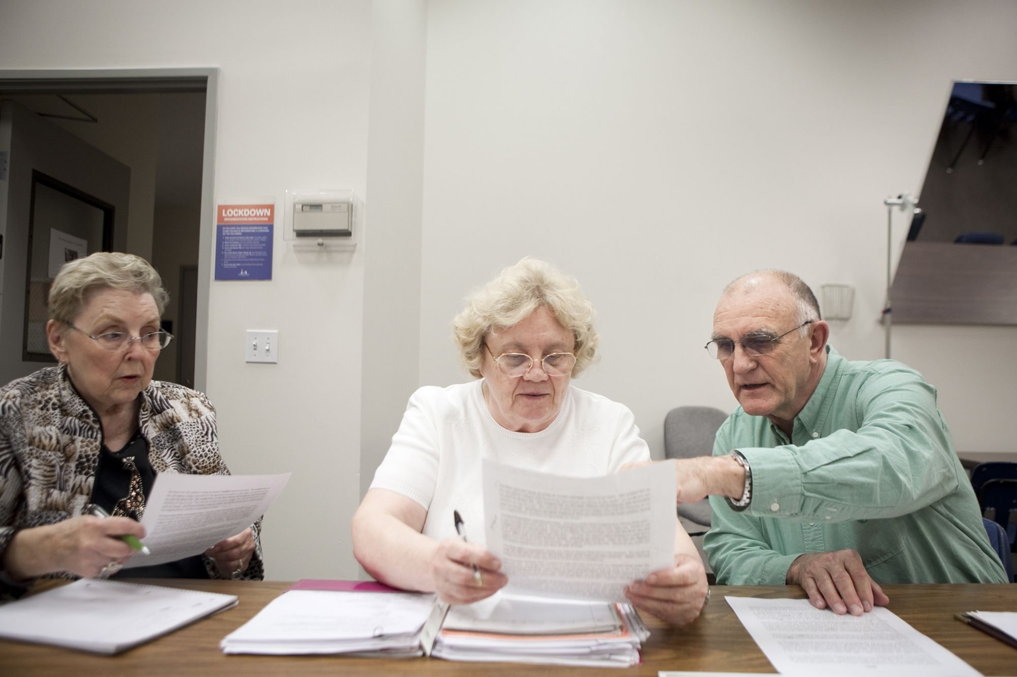 Barbara Saur, from left, Jean Moultrie and Robert Roy read over stories written by classmates in their creative writing class.