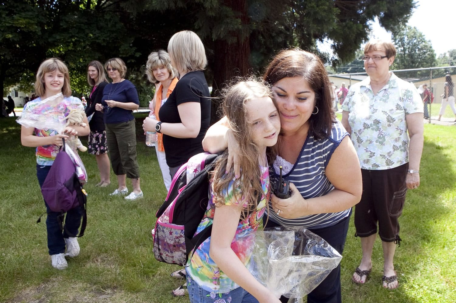 Miranda Eichner, a fifth-grade pupil at Hathaway Elementary School, hugs Principal Laura Bolt on Tuesday, the final school day for Washougal students.