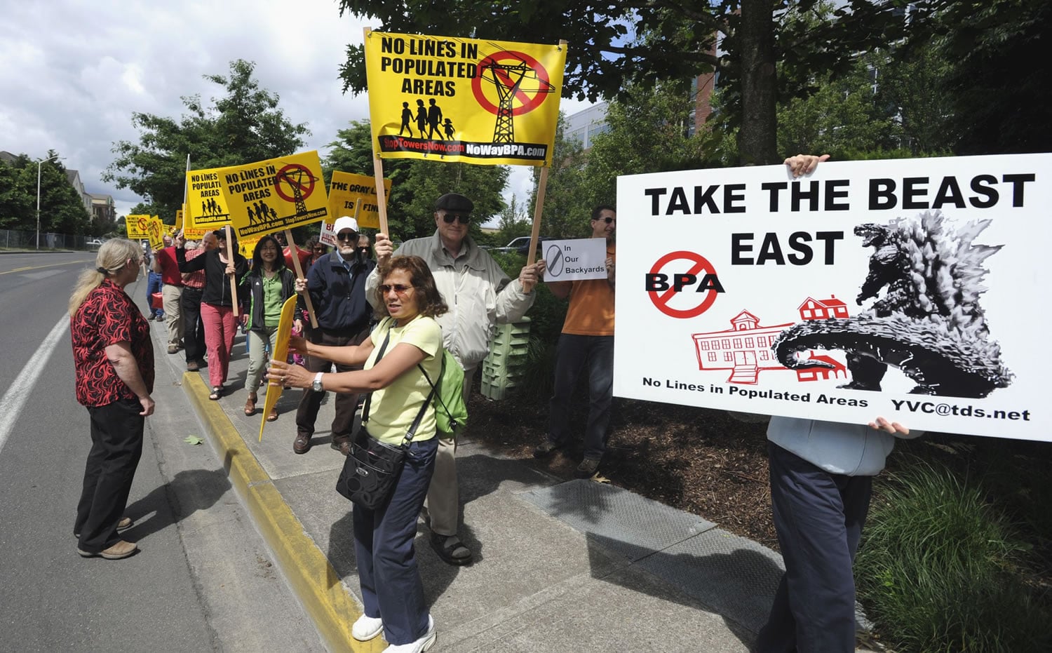 More than 100 protesters marched outside the Bonneville Power Administration offices in Vancouver Friday to demand that the BPA choose a route for a new transmission line that won't run through neighborhoods in Clark and Cowlitz counties.