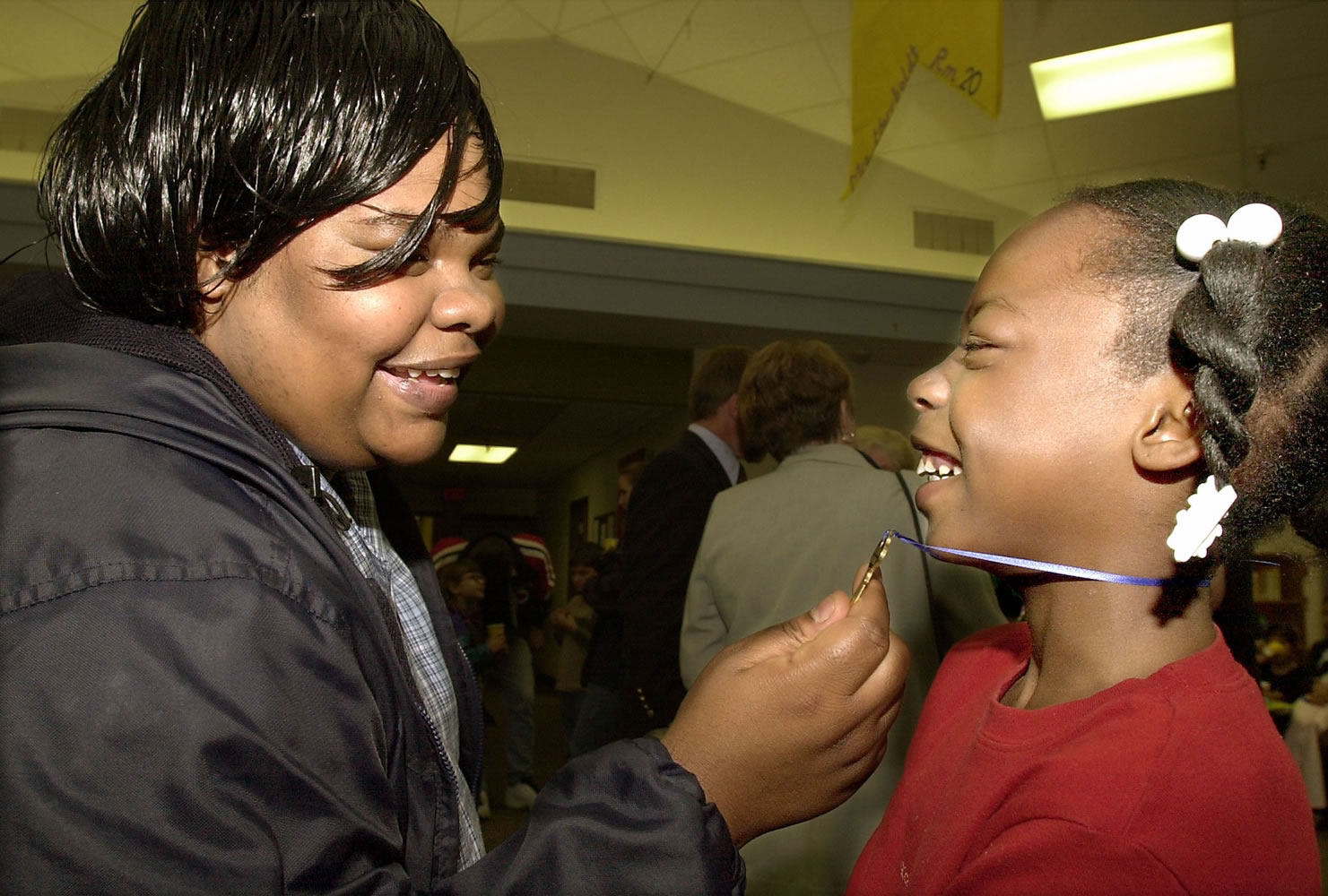 Shyquilia Hampton shows her mother, Lois Hester, the key that symbolized her class joining the I Have a Dream program at Martin Luther King Elementary School in 2001.