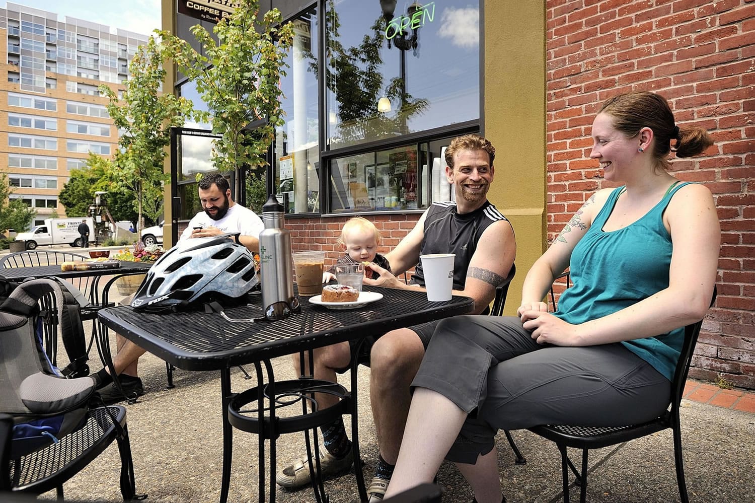Portland residents Rachel Fitch and her fiance Matt Reynolds, center, said downtown Vancouver's restaurants and coffee shops draw them and their 11-month-old son Joey to town.