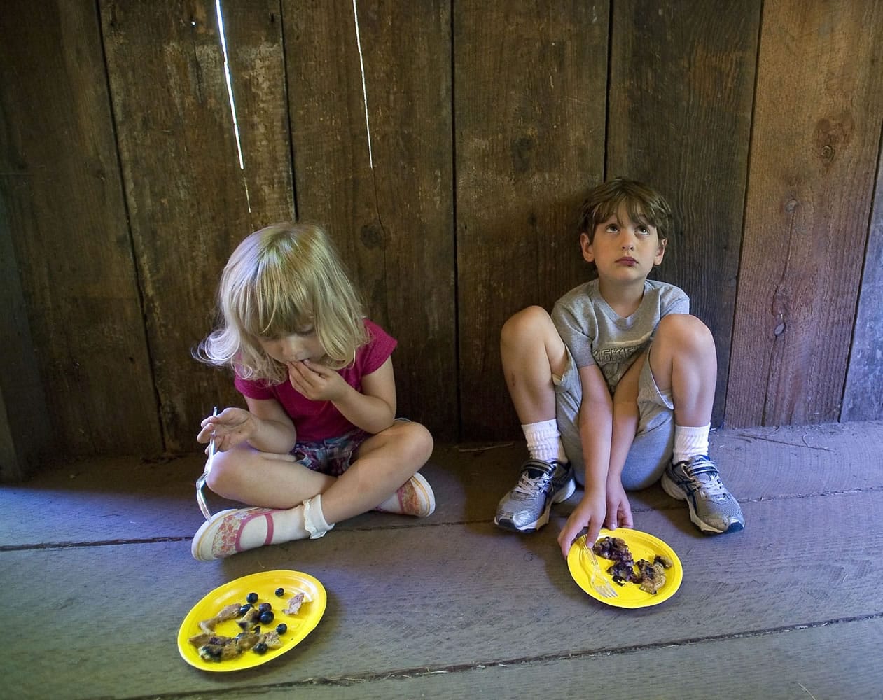 Three-year-old Addison Keeling, left, and her brother Jack, 6, both of La Center, sample some blueberry pancakes during a fundraiser Saturday at Cedar Creek Grist Mill.