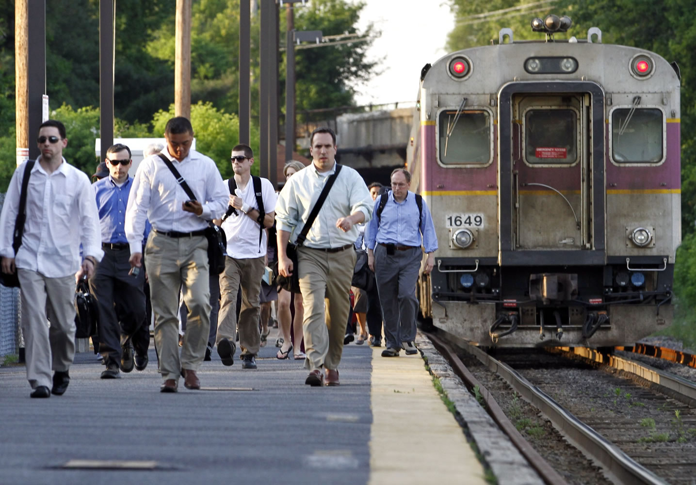 Commuters walk  June 7 on the platform at the Massachusetts Bay Transportation Authority train station in Andover, Mass.