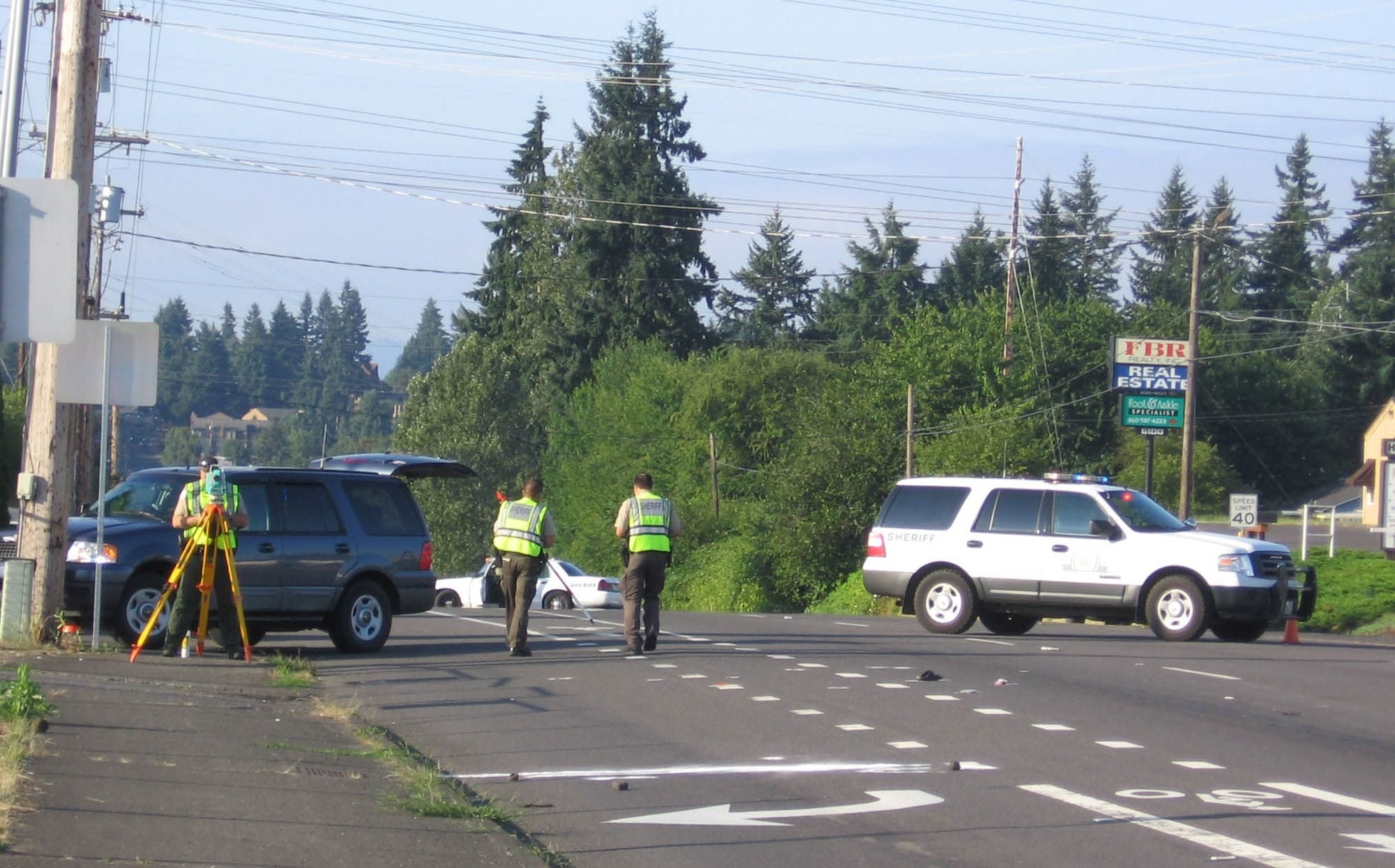 Sheriff's investigators process the scene of a crash that killed a pedestrian on Highway 99 this morning.