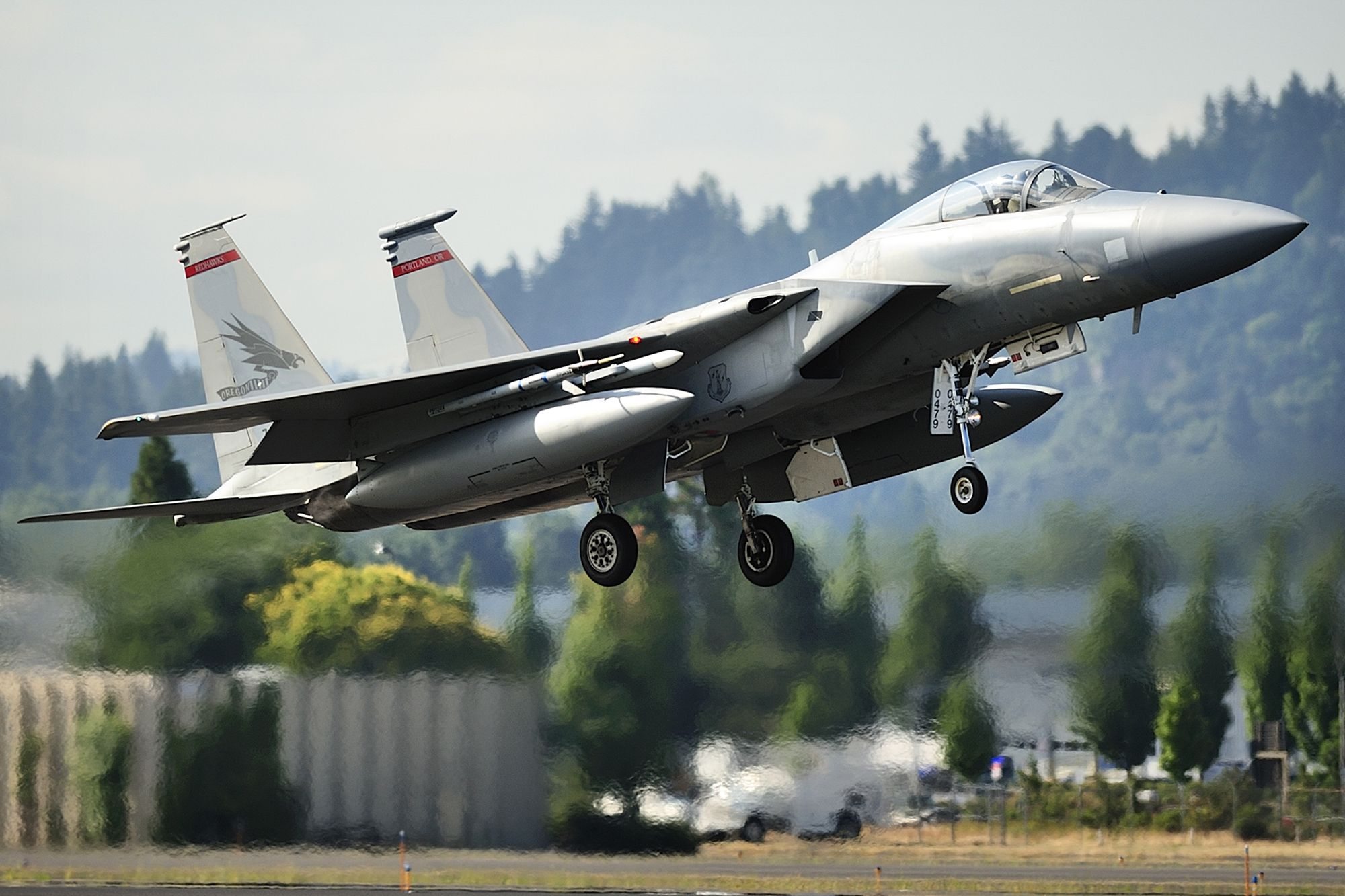 F-15 C model single seat jet fighters with the Oregon Air National Guard take off from Portland International Airport.