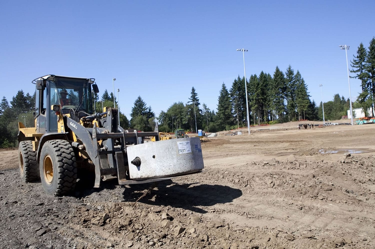 Construction on Luke Jensen Sports Park is under way, as a piece of the storm water drain system is moved into place.