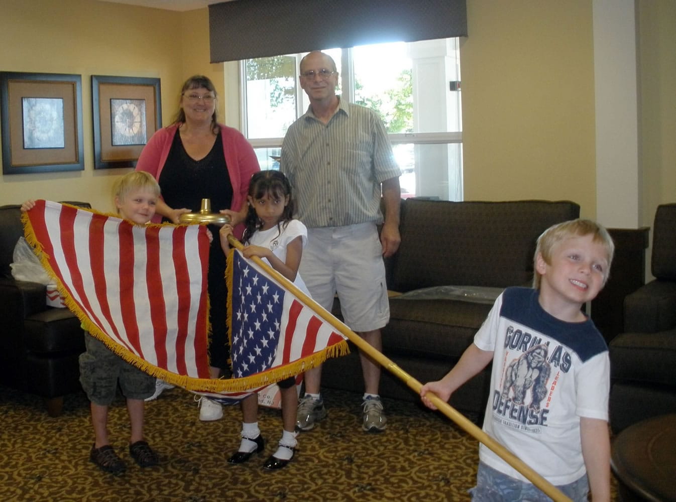 Landover-Sharmel: Vancouver Modern Woodmen of America director Sherree Filla, left, and husband Tim watch as members of the local chapter present a flag to the residents at Bridgewood at Four Seasons Retirement Center.