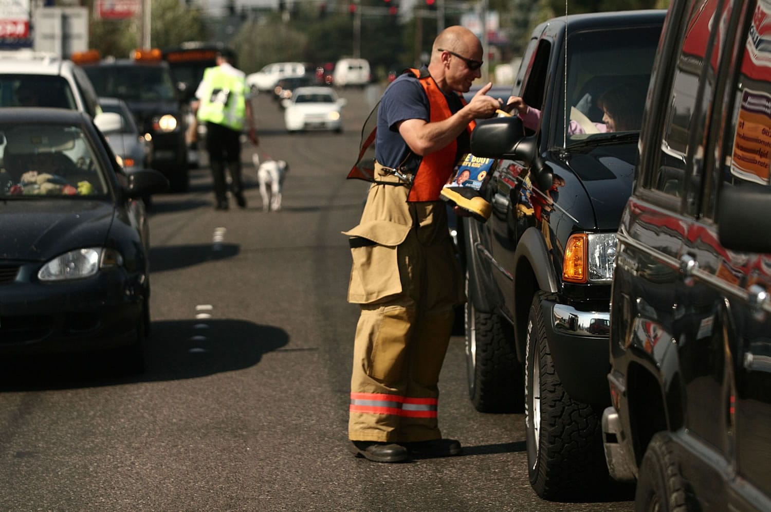 Vancouver Firefighter/paramedic Erik Rosendahl collects a donation for the 'Fill the Boot' fundraiser held by the Vancouver Firefighters Union near the corner of Fourth Plain Boulevard and Andresen Road in 2006.