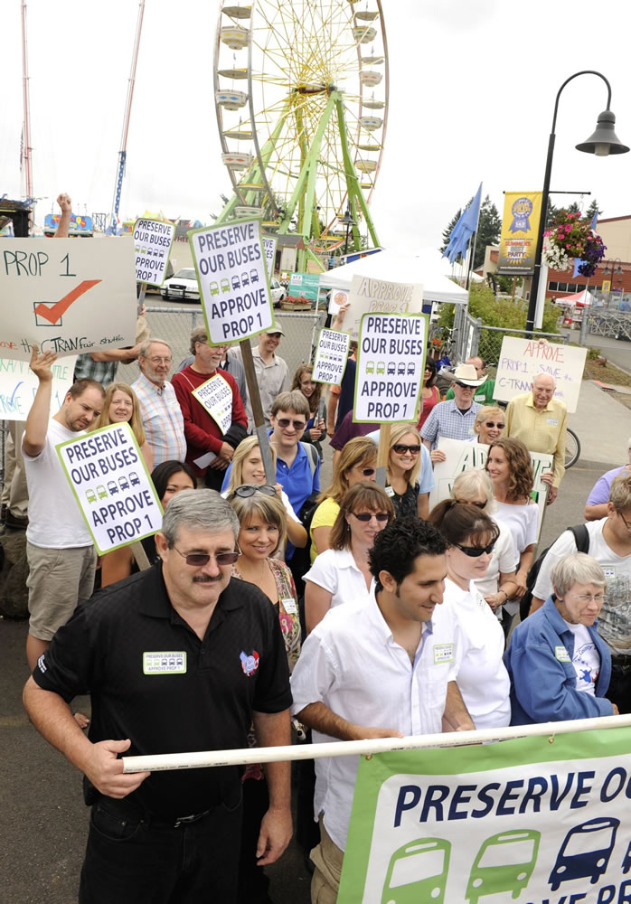 Supporters of Proposition 1, including Roy Jennings, bottom left, of the Amalgamated Transit Union 757, rally for C-Tran's sales tax increase outside the east entrance to the Clark County Fair on Saturday.