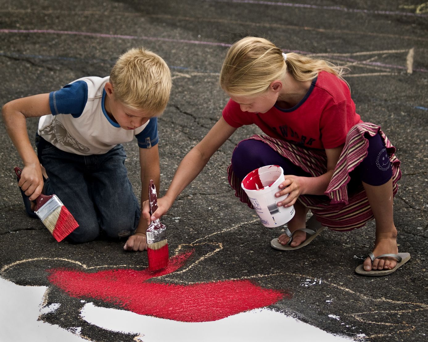 Vancouver Heights: Siblings Oleksiy and Marina Dobryden work together to help paint the Omaha Way street mural.