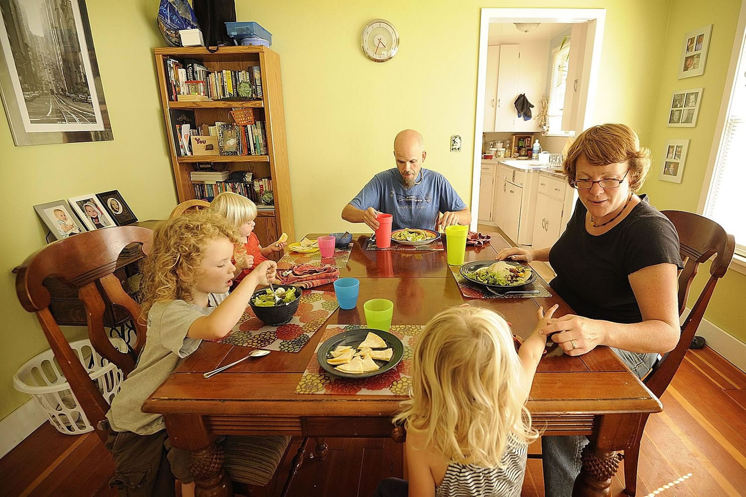 The Cowen family, clockwise from top center, Eric, Eileen, Marley, 3, Abraham, 4, and Bridget, 1, eat a dinner of red beans, tortillas and fresh vegetables at their Vancouver home.