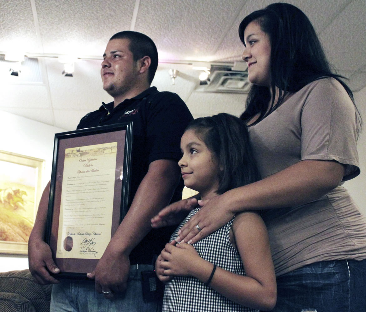 Antonio Diaz Chacon poses with his wife, Martha, and their daughter, Brisseida, after he was recognized for his heroism during a ceremony in Albuquerque, N.M., on Friday.