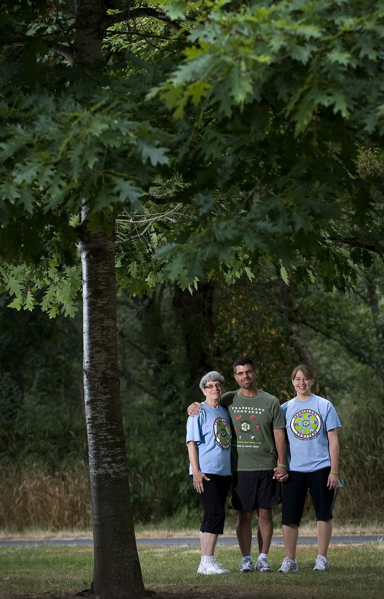 Lee Golden, center, poses for a portrait with his mother, Dolores Golden, left, and his fiancee, Laurie Scheer, on the Salmon Creek Trail near Klineline Pond on Monday. Delores donated a kidney to her son in 2000 after he was diagnosed with kidney disease. Laurie is also a kidney recipient.