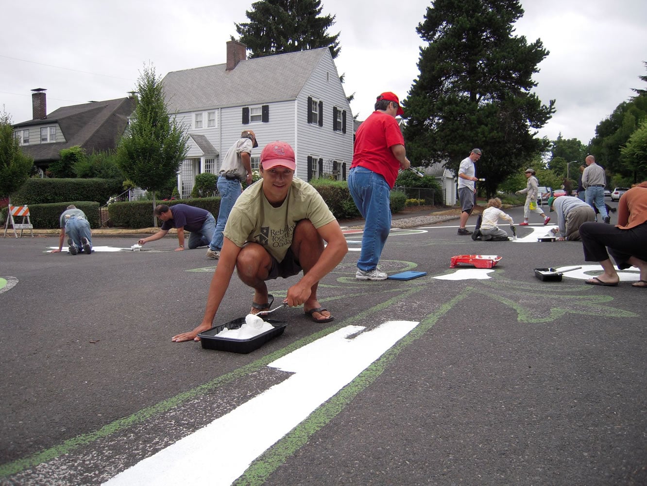 Josh Oliva helps repaint the Arnada Neighborhood street mural.
