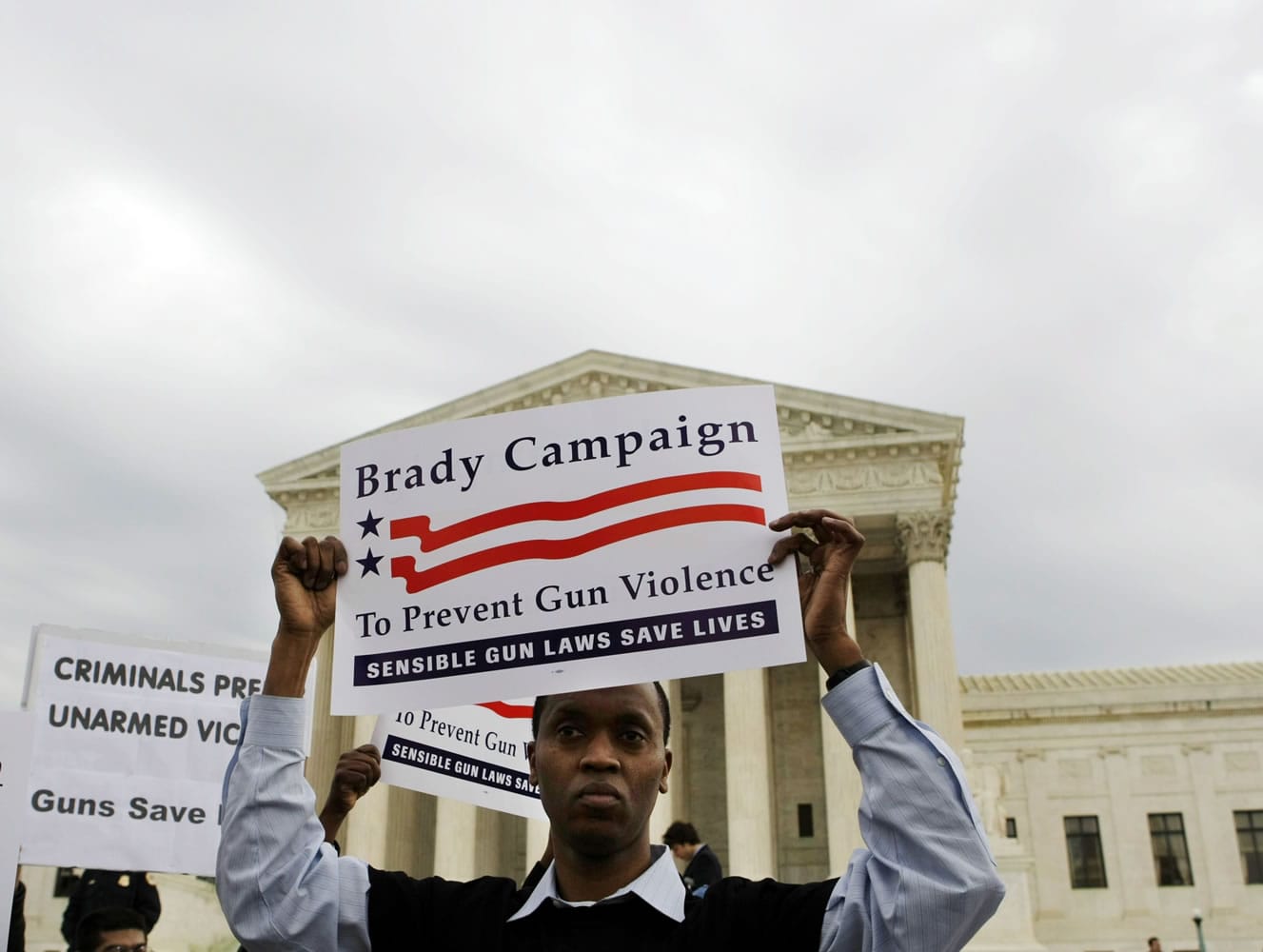 Leon McMillian from Washington, a supporter of the District of Columbia's firearms ban, stands outside the Supreme Court in Washington, Tuesday, March 18, 2008, as the court heard arguments in an attempt to overturn the ban.