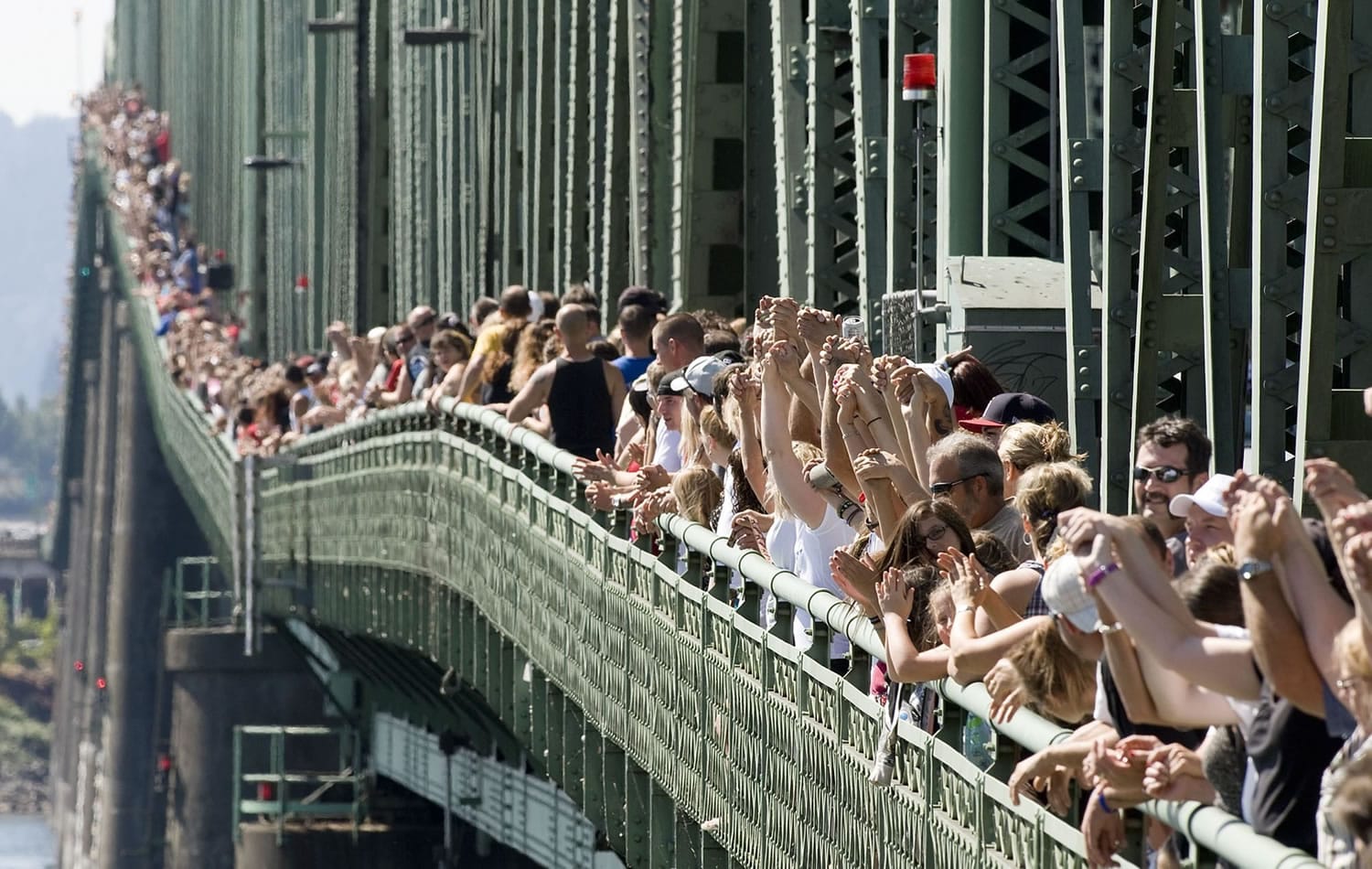 Nearly 2,300 people filed onto the Interstate 5 Bridge for the 10th annual Hands Across the Bridge event Monday to celebrate those recovering from addiction, as well as mark the beginning of National Alcohol and Drug Addiction Recovery Month.