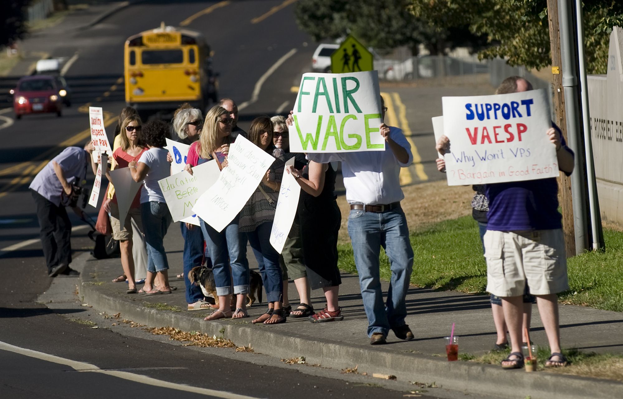Picketing Vancouver school district employees line Falk Road near Eleanor Roosevelt Elementary School late Tuesday.