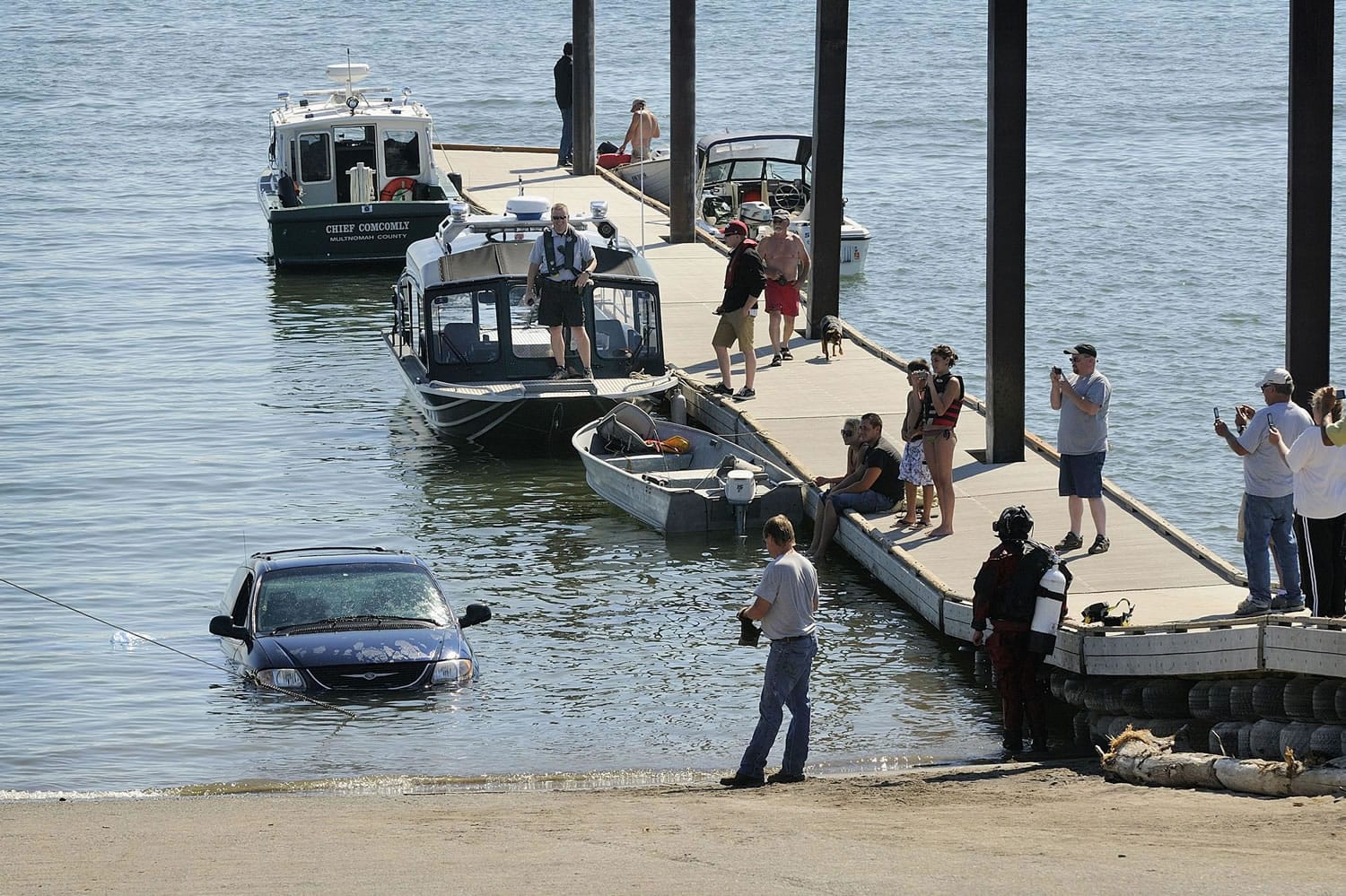 Robert Sharp's minivan is pulled from the Columbia River at the Marine Park boat launch Tuesday after his wife, Teresa, backed too far down the ramp while putting their boat in the water.
