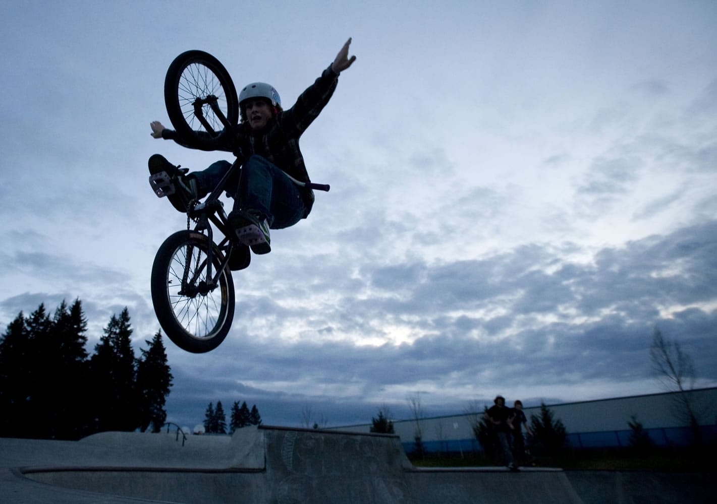 Justin Zuvich uses the last moments of daylight to practice his bike tricks at Pacific Community Park.