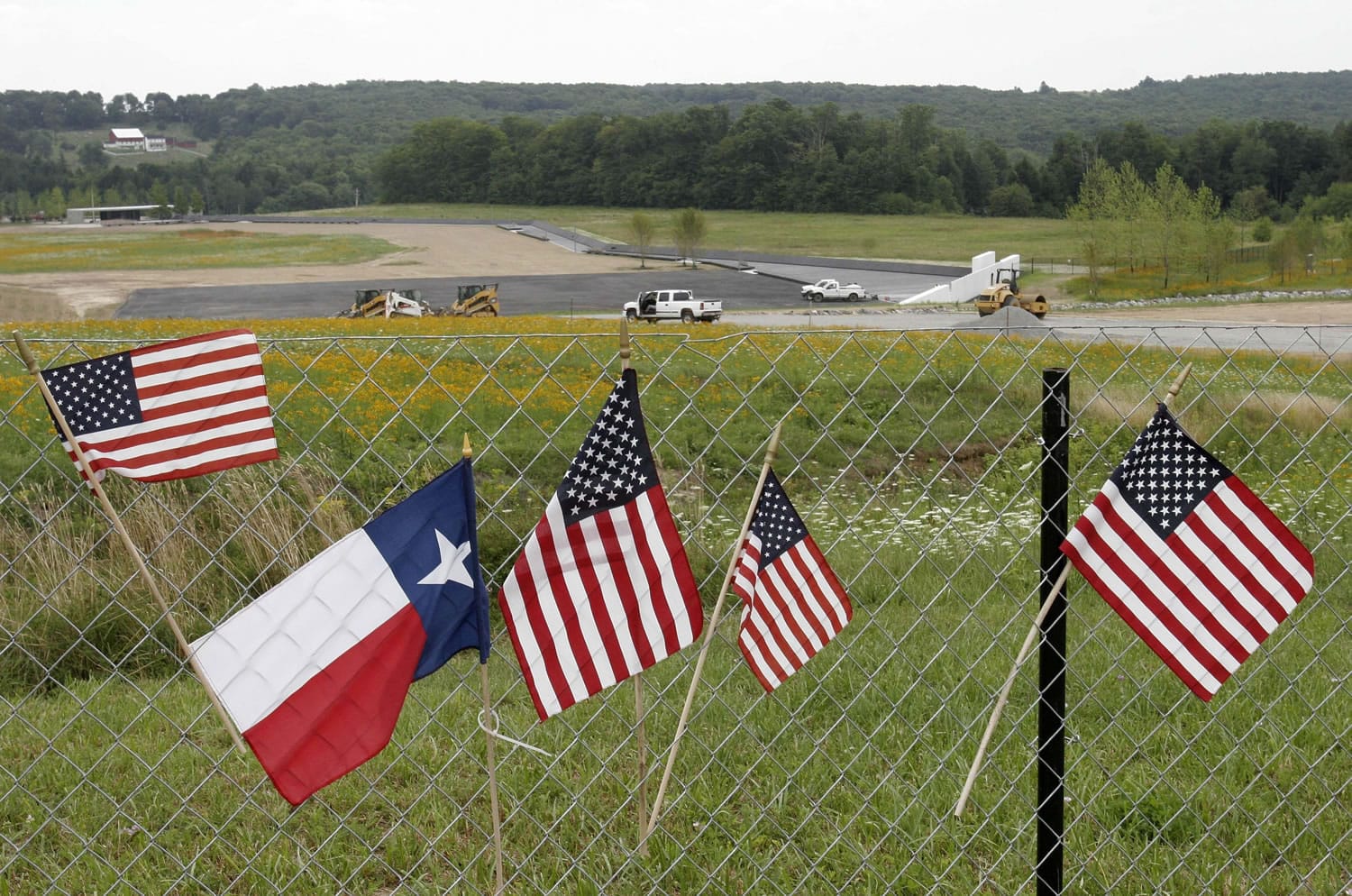 Flags hang on a fence overlooking the crash site of Flight 93 in Shanksville, Pa.