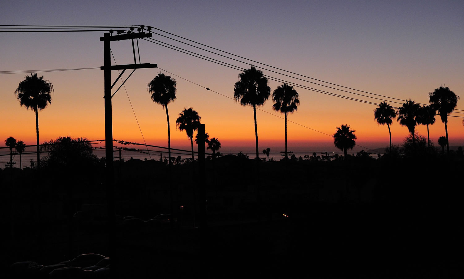 The sun sets Thursday in San Clemente, Calif. as homes sit below in the darkness during a power outage. There were no catastrophes caused by the widespread outage that knocked out power in a region with a population of nearly 6 million spanning both sides of the U.S.-Mexico border.