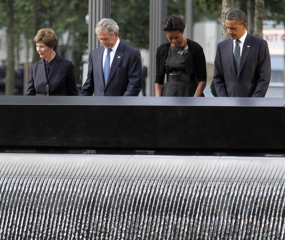 President Barack Obama, from right, first lady Michelle Obama, former President George W. Bush and former first lady Laura Bush observe a moment of silence at the National September 11 Memorial during a ceremony marking the 10th anniversary of the Sept.