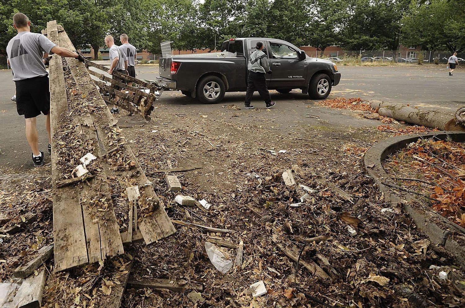 Personnel from the Washington Army National Guard's 790th Chemical Company clean up debris at a Vancouver Barracks maintenance facility Wednesday. It was the final day of military presence at the site that became a U.S.