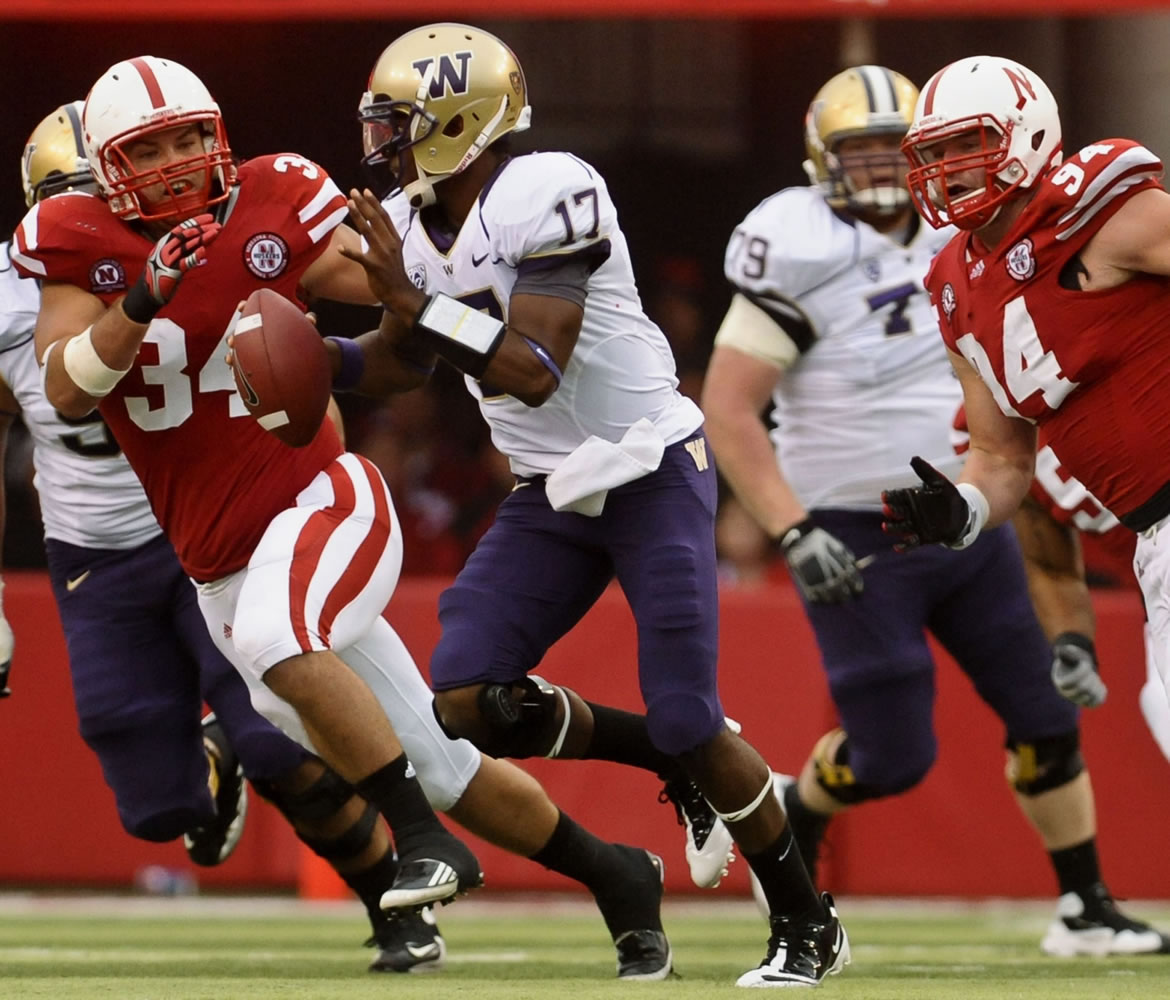 Washington quarterback Keith Price (17) is under pressure from Nebraska's Cameron Meredith (34) and Jared Crick (94) in the second half Saturday.